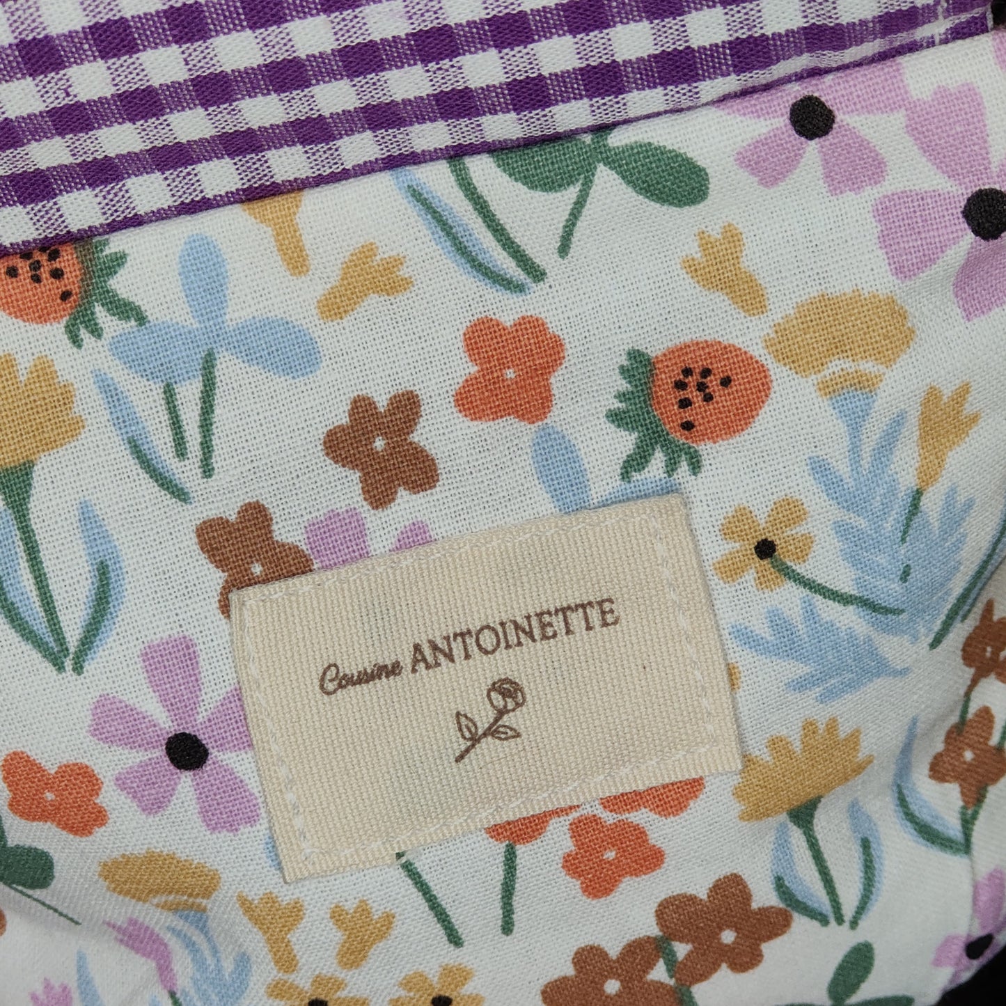 Porte-monnaie Léon de Cousine Antoinette en tissu lilas avec fermeture éclair et détails élégants.